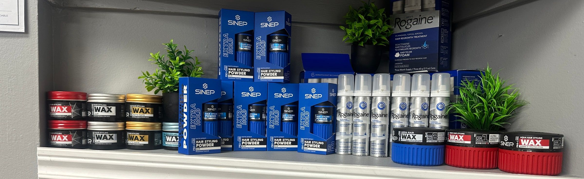 Hair wax, texture powder and styling products on the shop shelf